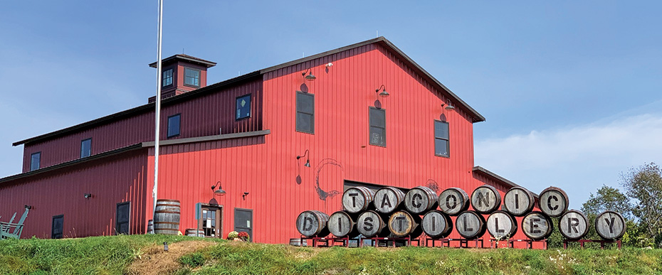 red barn with barrels in front