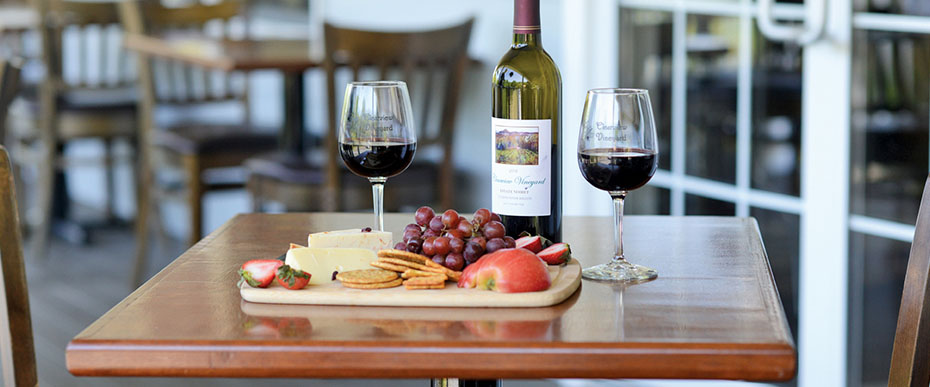Bottle and two glasses of Clearview wine accompanied by a cheeseboard