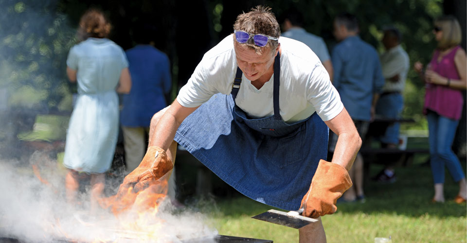 Chef Marc Murphy cooking on outdoor grill with smoke