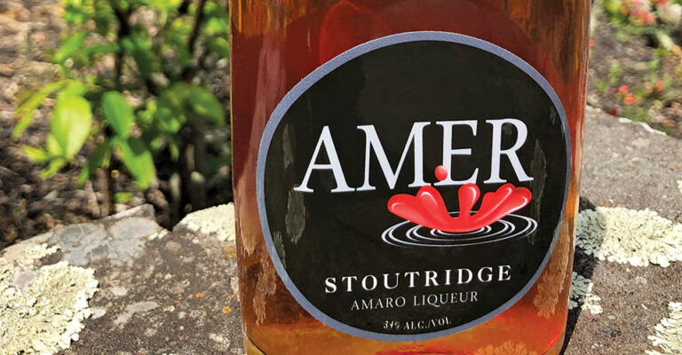 bottle of brown liquor on rock
