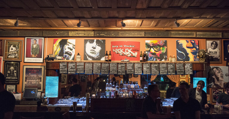 view of dark bar with music posters on wall