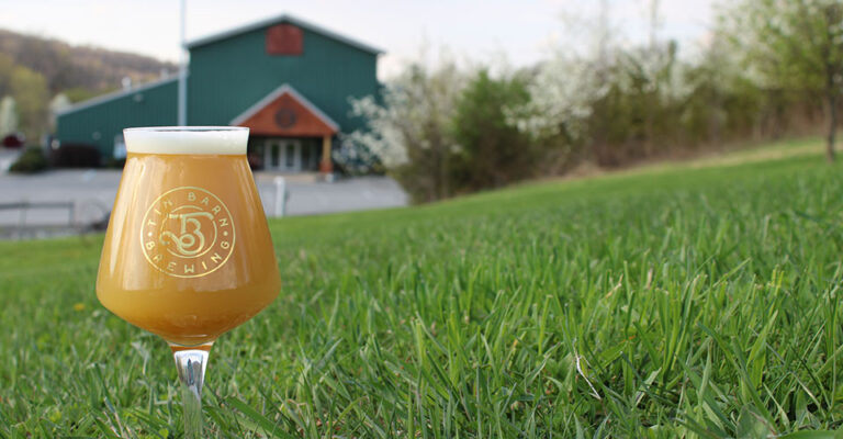 closeup of beer on lawn with soft focus building in background