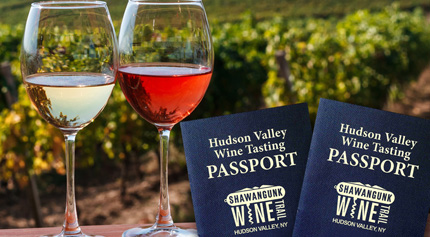 view of red and white glasses of wine, with Shawangunk Wine Trail's Hudson Valley Wine Tasting Passports.