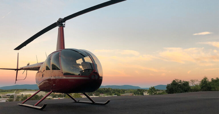 view of an Independant Helicopter with scenery and sunset in background.