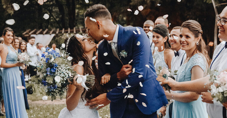 bride and groom kissing at outdoor wedding