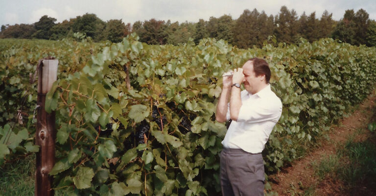 vintage photo of man with refractometer in vineyard